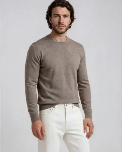 Uomo indossa un elegante maglione in cashmere beige, perfetto per uno stile sofisticato e confortevole. Ideale per look casual o formali, realizzato con materiali di alta qualità.