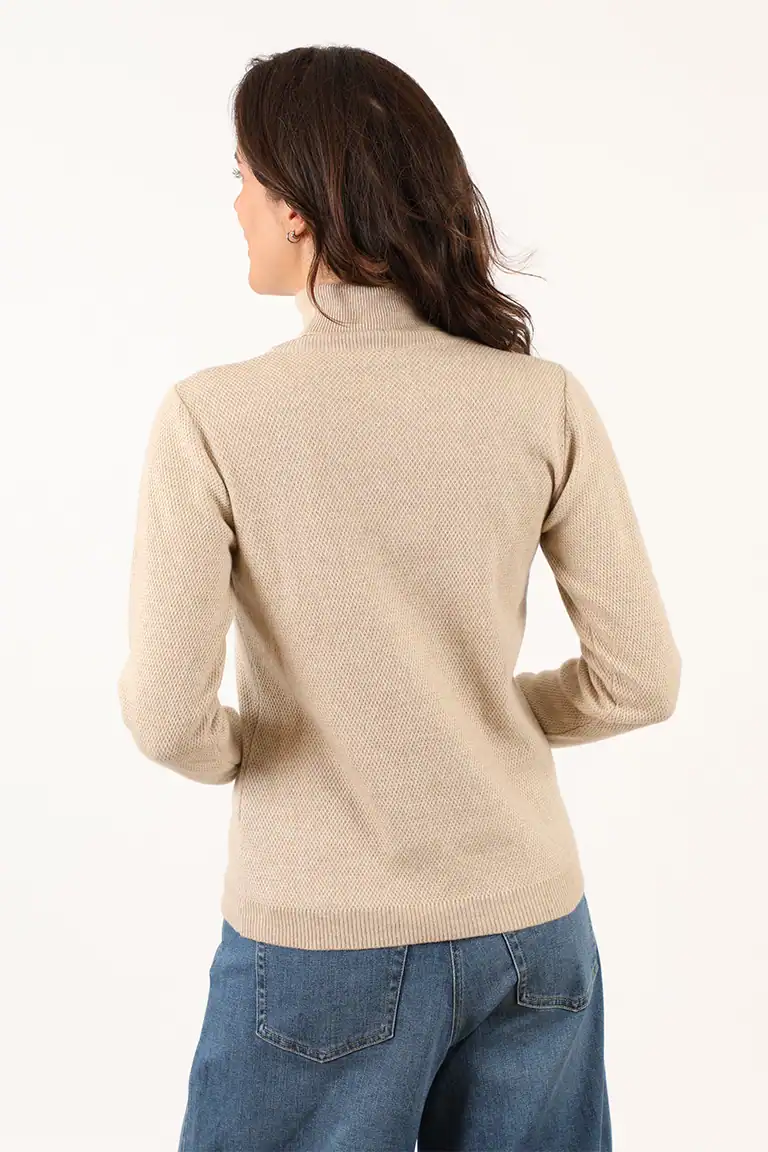 Maglificio Annamaria - Donna con maglione beige e jeans, vista posteriore, moda autunnale, abbigliamento di qualità, stile casual elegante.