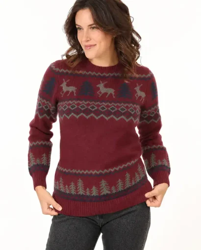 Women wearing a red wool crew neck sweater with Alpine style reindeer and pine tree patterns, suitable for men and women, from Maglificio Annamaria.